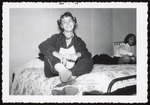 Student with Pig Tails Sitting on Bed, Westbrook Junior College, 1956